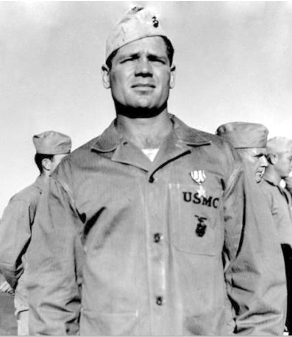 Lieutenant Howard “Smiley” Johnson had played two seasons with the Green Bay Packers before joining the 23rd Marine Regiment. He earned a Silver Star at Saipan; this photo depicts that award.