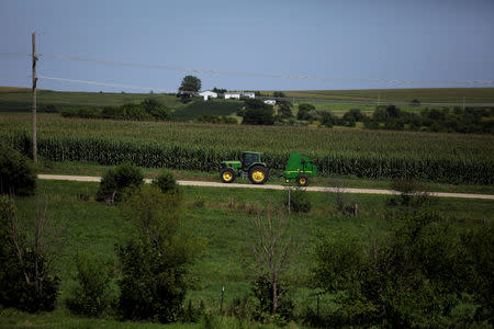 FILE PHOTO: A farmer drives tractor along a road in Pearl City, Illinois, U.S., July 25, 2018. REUTERS/Joshua Lott/File Photo