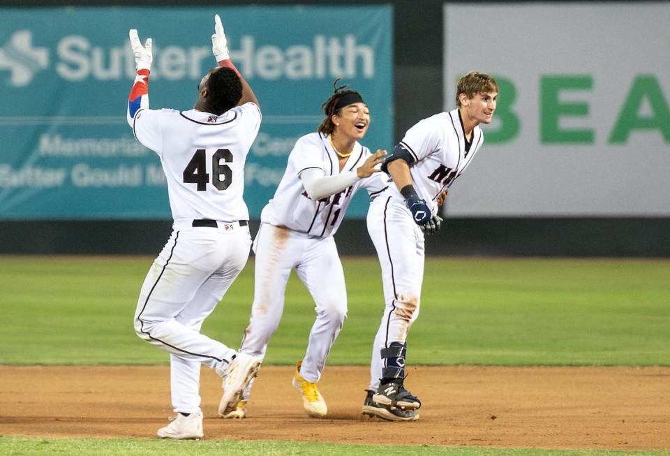 Modesto Nuts’ Tai Peete, Colt Emerson, right, and Lazaro Montes (46) celebrate Emerson’s walk off hit to win the first game in the California League playoff series over San Jose at John Thurman Field in Modesto, Calif., Tuesday, September 12, 2023. Modesto won the game 6-5 in 10 innings.