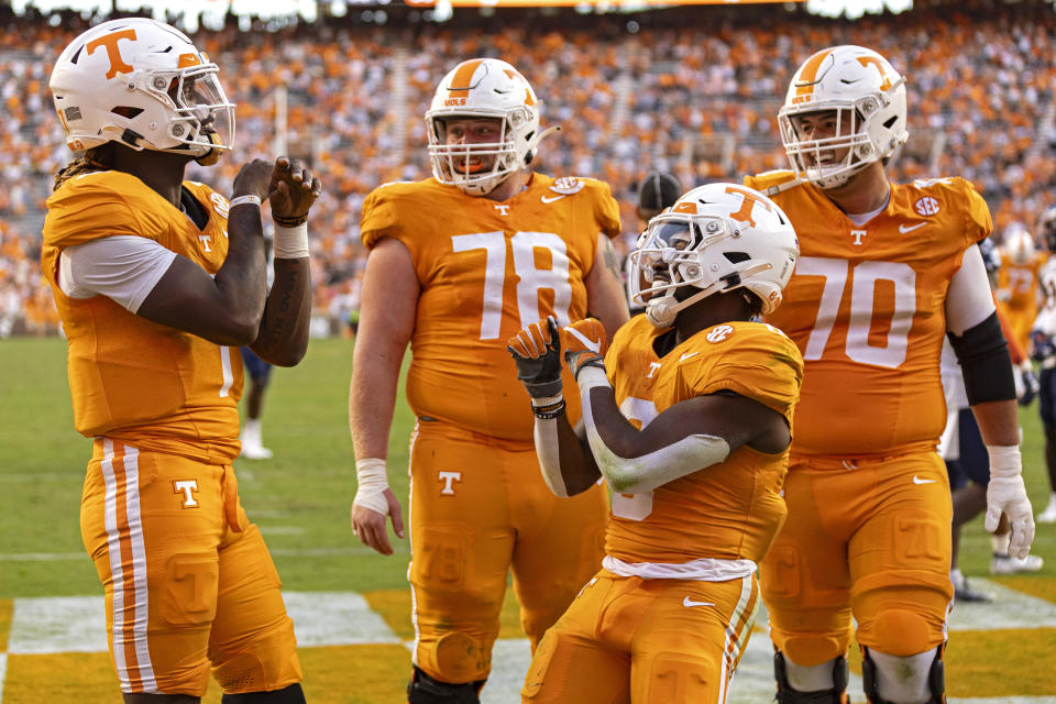 Tennessee running back Dylan Sampson (6) celebrates after a touchdown with quarterback Joe Milton III (7), offensive lineman Ollie Lane (78), and offensive lineman Andrej Karic (70) during the second half of an NCAA college football game against UTSA Saturday, Sept. 23, 2023, in Knoxville, Tenn. (AP Photo/Wade Payne)