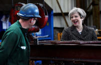 Britain's Prime Minister Theresa May chats to a worker during a visit to a steel works in Newport, Wales, April 25, 2017. REUTERS/Rebecca Naden