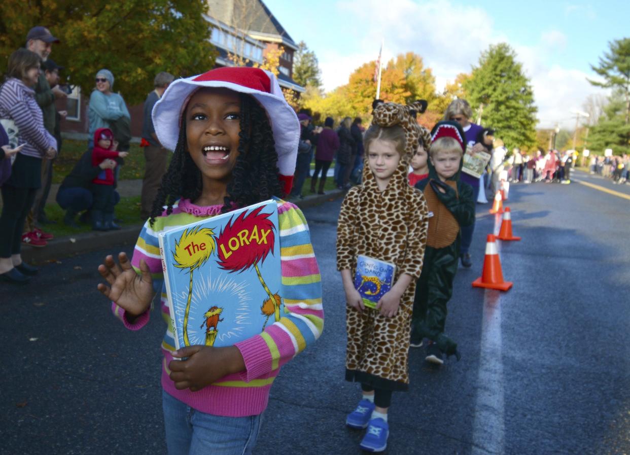 Williamstown Elementary School children  participate in a character parade as part of their week-long "Words are Wonderful" events which is in its 22nd year, Wednesday, Oct. 23, 2019 in Williamstown, Mass. Students, teachers and staff dressed as their favorite book character, or word, and marched with the book from which their character lives. The costume parade coincides with Halloween which is only a week away. (Gillian Jones/The Berkshire Eagle via AP)