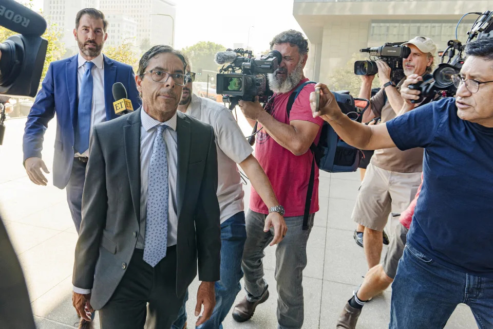 Dr. Mark Chavez, a physician from San Diego, second from left, who is charged in connection with actor Matthew Perry's death from an accidental ketamine overdose, with his criminal defense attorney Matthew Binninger, far left, arrive for a change of plea hearing at the United States Courthouse in Los Angeles on Wednesday, Oct. 2, 2024. (AP Photo/Damian Dovarganes)