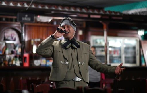 Venezuelan nurse Edgar Fernandez, who works at a state hospital, sings in mariachi costume at a restaurant at the town of El Junquito near Caracas