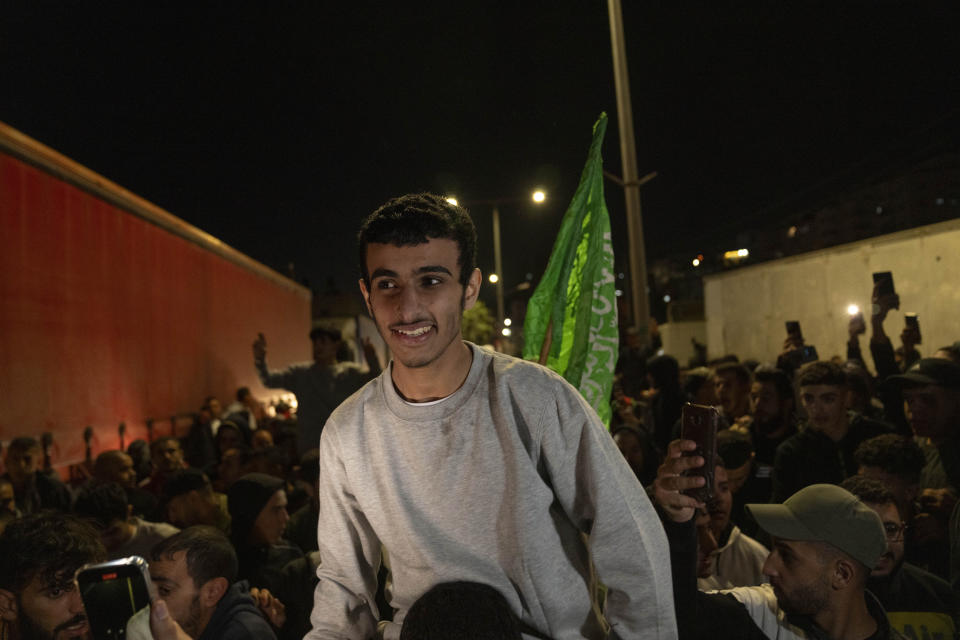 Former Palestinian prisoners who were released by the Israeli authorities, are carried on the shoulders upon their arrival in the West Bank town of Beitunia, Friday, Nov. 24, 2023. The release came on the first day of a four-day cease-fire deal between Israel and Hamas during which the Gaza militants have pledged to release 50 hostages in exchange for 150 Palestinians imprisoned by Israel. (AP Photo/Nasser Nasser)