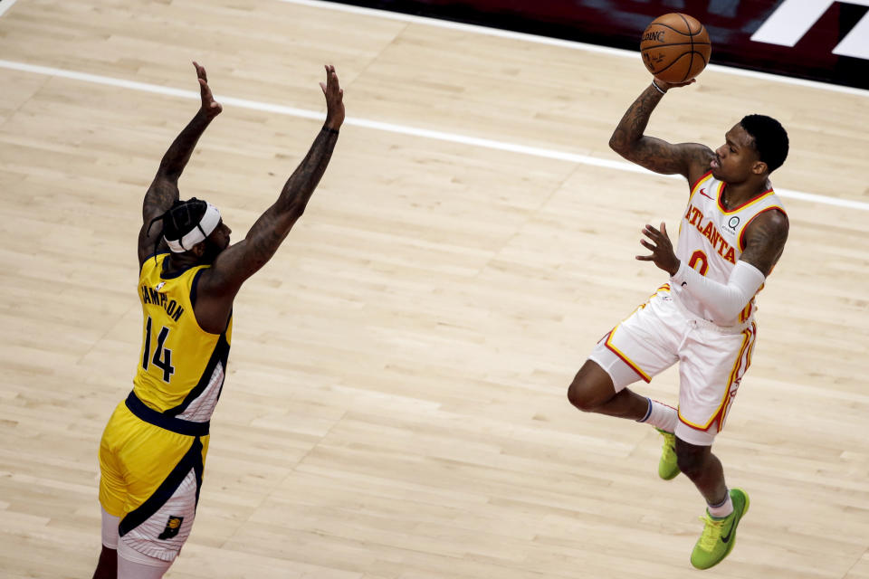 Atlanta Hawks guard Brandon Goodwin (0) puts up a shot over Indiana Pacers forward JaKarr Sampson (14) during the second quarter of an NBA basketball game Saturday, Feb. 13, 2021, in Atlanta. (AP Photo/Butch Dill)
