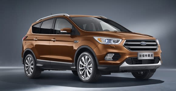 A brown 2017 Ford Kuga, a compact SUV, with Chinese license plates.