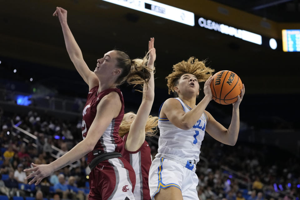 UCLA guard Kiki Rice, right, shoots past Washington State guards Kyra Gardner, left, and Tara Wallack during the second half of an NCAA college basketball game, Sunday, Jan. 28, 2024, in Los Angeles. (AP Photo/Ryan Sun)