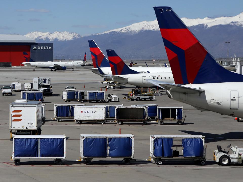 FILE PHOTO: Delta Airlines planes are loaded and unloaded as travel has cutback amid concerns of the coronavirus disease (COVID-19), at Salt Lake City International Airport in Salt Lake City, Utah, U.S. April 14, 2020. REUTERS/Jim Urquhart