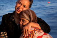 <p>Ahma, 24, and Habsa, 26, left, sit in a rigid inflatable boat after been rescued from a crowded wooden boat as they were fleeing Libya, during a rescue operation in the Mediterranean sea, about 13 miles north of Sabratha, Libya, Monday, Aug. 29, 2016. (AP Photo/Emilio Morenatti) </p>