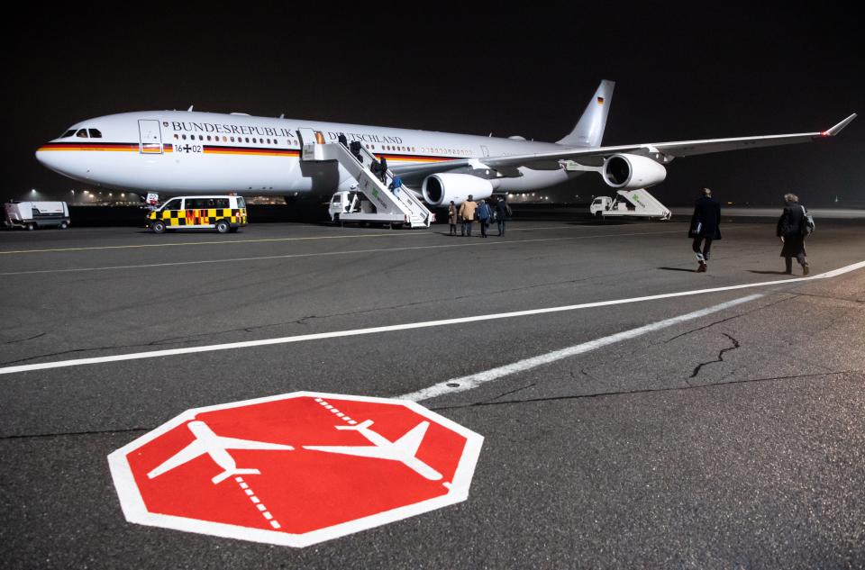 Germany's VIP Airbus A340 16+02 on the tarmac at night.