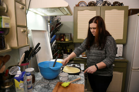 Liza Ludmann-Vank prepares pancakes for her three children on the outskirts of Budapest, Hungary, February 16, 2019. Picture taken February 16, 2019. REUTERS/Tamas Kaszas