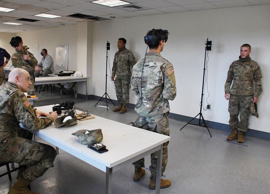 Army soldiers use the digital thermal sensors in modified IVAS goggles to look for fevers in Army personnel at Fort Benning, Georgia.