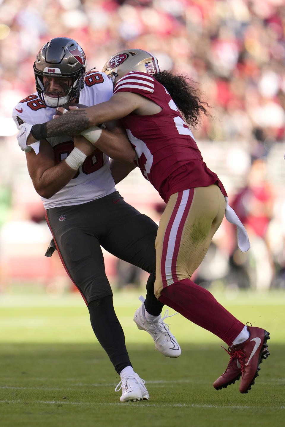 Tampa Bay Buccaneers tight end Cade Otton (88) is tackled by San Francisco 49ers safety Talanoa Hufanga during the first half of an NFL football game in Santa Clara, Calif., Sunday, Nov. 19, 2023. (AP Photo/Godofredo A. Vásquez)