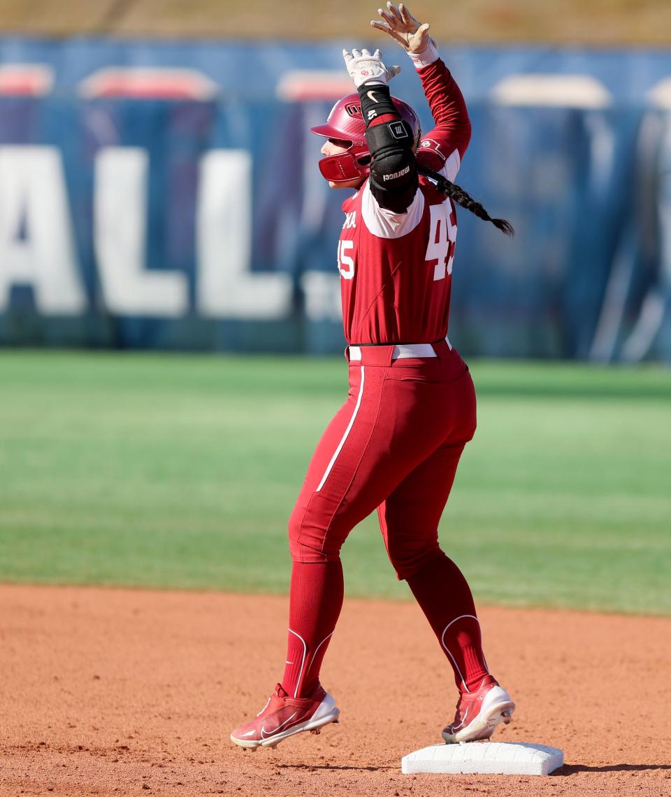 Oklahoma's Haley Lee (45) celebrates after hitting a double in the first inning of a college softball game between the University of Oklahoma Sooners (OU) and the Weber State Wildcats at USA Softball Hall of Fame Stadium in Oklahoma City, Saturday, March 18, 2023. 