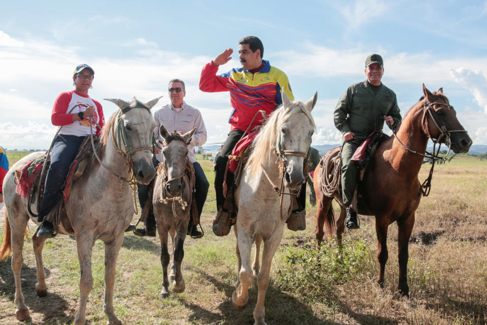 Venezuela's President Nicolas Maduro (2nd R) rides a horse next to Defense Minister Vladimir Padrino Lopez (R) during an event related to a government plan for planting and harvesting cereal crops, in San Carlos, Venezuela, September 22, 2016. Miraflores Palace/Handout via REUTERS ATTENTION EDITORS - THIS PICTURE WAS PROVIDED BY A THIRD PARTY. EDITORIAL USE ONLY.     TPX IMAGES OF THE DAY     