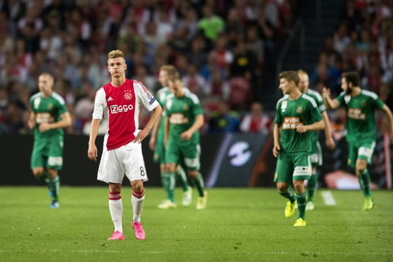 Ajax's Dutch midfielder Daley Sinkgraven (2-L) reacts after losing to Rapid Wien on August 4, 2015 at the Arena Stadium in Amsterdam