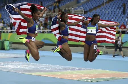 2016 Rio Olympics - Athletics - Final - Women's 100m Hurdles Final - Olympic Stadium - Rio de Janeiro, Brazil - 17/08/2016. Brianna Rollins (USA) of USA, Nia Ali (USA) of USA and Kristi Castlin (USA) of USA celebrate after they won gold, silver and bronze respectively. REUTERS/Phil Noble