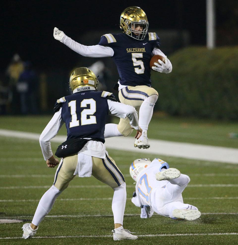 Salesianum receiver Lukas Ryan avoids Cape Henlopen's Camryn Joyner in the second quarter of the DIAA Class 3A state championship at Delaware Stadium, FridaCy, Dec. 1, 2023.