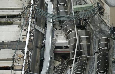 A derailed New Jersey Transit train is seen under a collapsed roof after it derailed and crashed into the station in Hoboken, New Jersey, U.S. September 29, 2016. REUTERS/Carlo Allegri