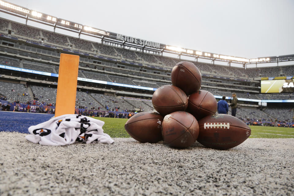 Footballs are placed on the field before an NFL football game between the New York Giants and the Los Angeles Rams Sunday, Nov. 5, 2017, in East Rutherford, N.J. (AP Photo/Julio Cortez)