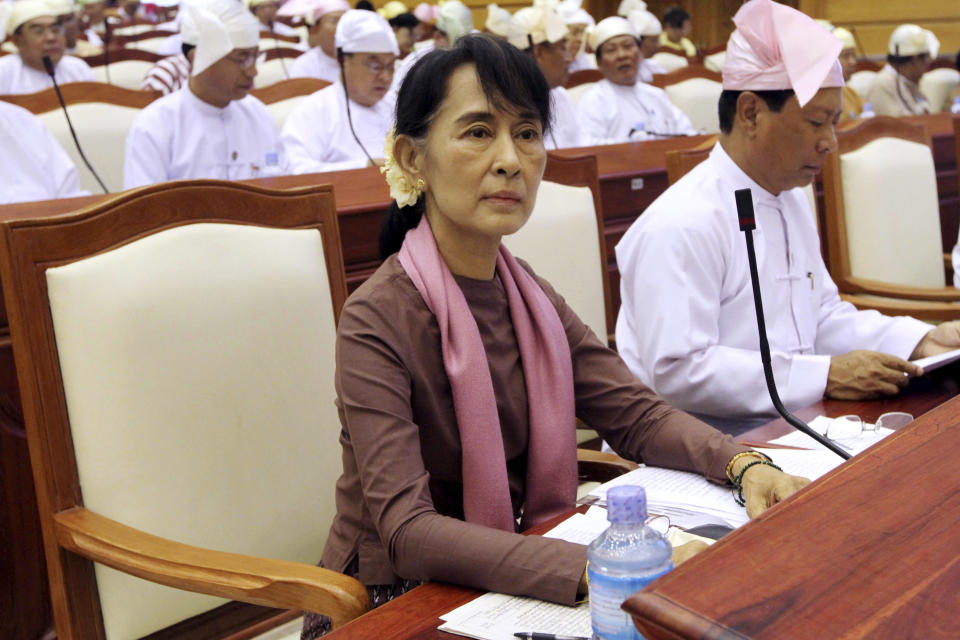 FILE - Myanmar's opposition leader Aung San Suu Kyi, bottom left, attends a regular session of the parliament at Myanmar Lower House in Naypyitaw, Myanmar on Aug. 14, 2012. Myanmar court on Monday, Dec. 6, 2021, sentenced ousted leader Suu Kyi to 4 years for incitement and breaking virus restrictions, then later in the day state TV announced that the country's military leader reduced the sentence by two years. (AP Photo/Khin Maung Win, File)