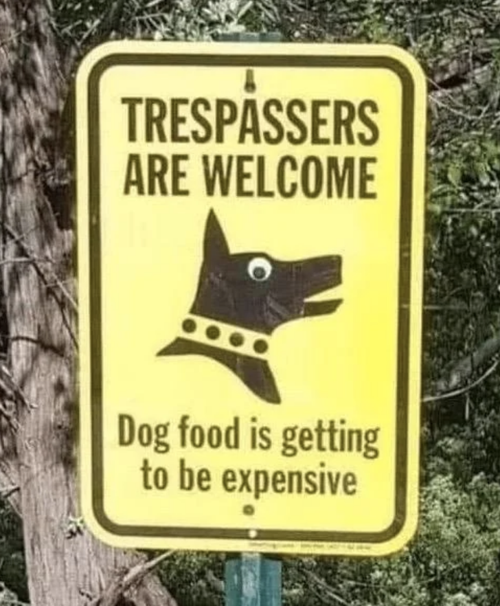 Sign with a dog illustration reads, "Trespassers are welcome. Dog food is getting to be expensive."