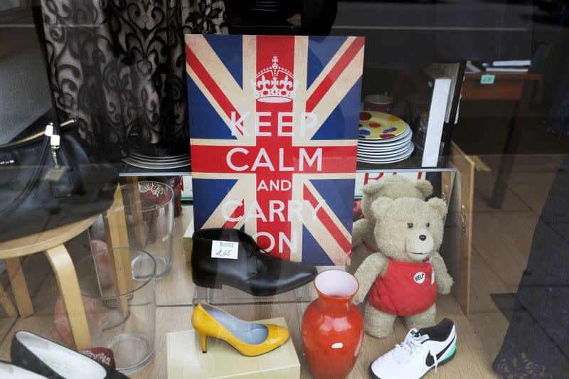 FILE PHOTO: A "Keep Calm and Carry On" sign is seen in the window of a closed charity store