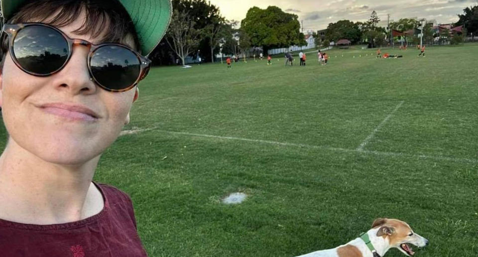 A photo of Greens South Brisbane MP, Amy MacMahon, walking her dog in the park.