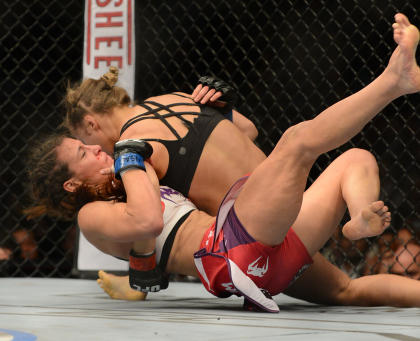 Ronda Rousey (top) has the advantage over Miesha Tate during their January 2014 bout. (USA TODAY Sports)