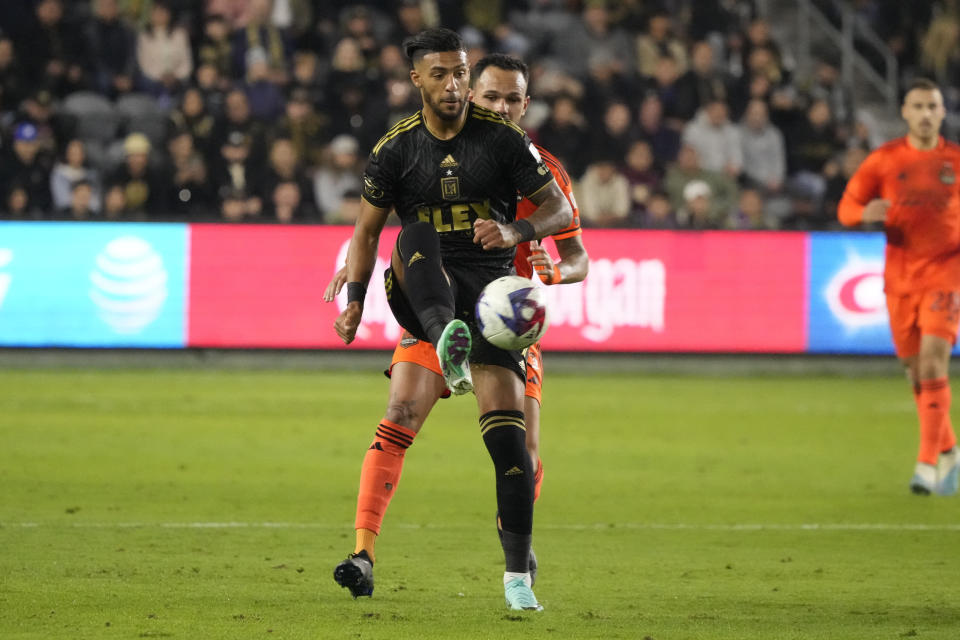 Los Angeles FC forward Denis Bouanga traps the ball in front of Houston Dynamo midfielder Artur during the first half in the MLS playoff Western Conference final soccer match Saturday, Dec. 2, 2023, in Los Angeles. (AP Photo/Marcio Jose Sanchez)