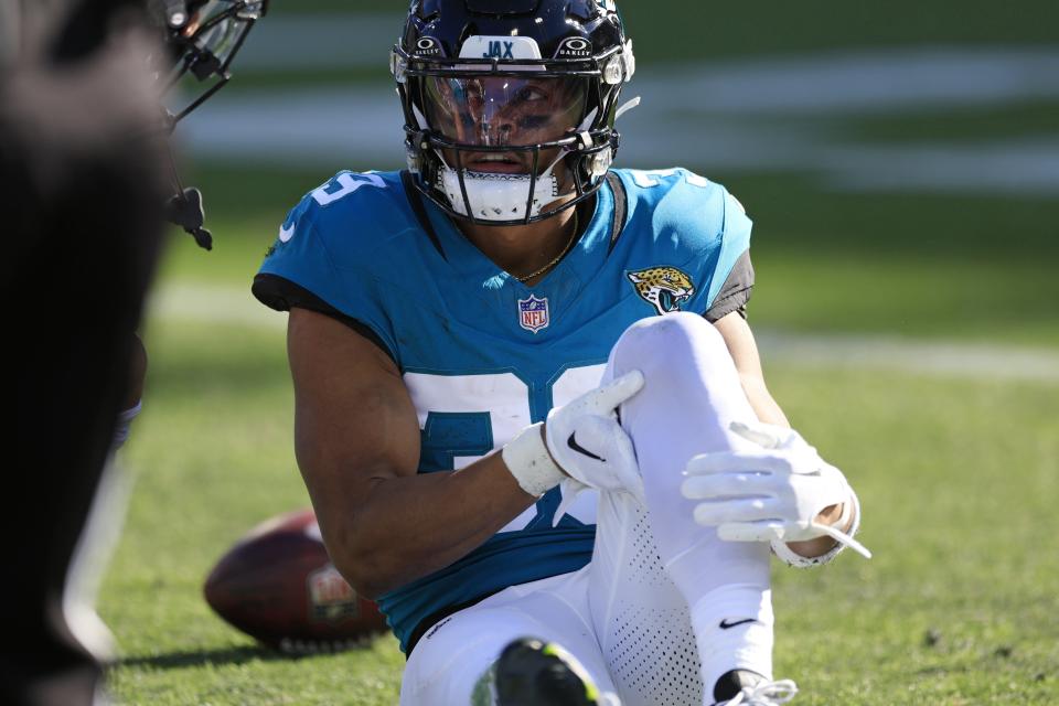 Jamal Agnew of the Jaguars reaches for his injured left leg after catching a 48-yard pass from C.J. Beathard during Sunday's 26-0 victory over Carolina, at EverBank Stadium.