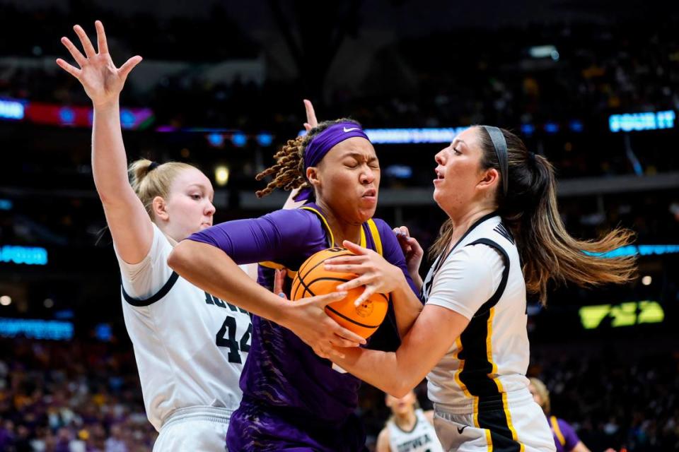 Apr 2, 2023; Dallas, TX, USA; LSU Lady Tigers forward LaDazhia Williams (0) controls the ball against Iowa Hawkeyes forward Addison O’Grady (44) and forward McKenna Warnock (14) in the first half during the final round of the Women’s Final Four NCAA tournament at the American Airlines Center. Mandatory Credit: Kevin Jairaj-USA TODAY Sports