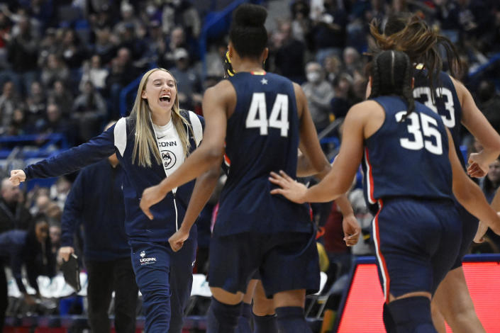 Connecticut's Paige Bueckers, left, reacts toward her team during the first half of an NCAA collage basketball game against North Carolina State, Sunday, Nov. 20, 2022, in Hartford, Conn. (AP Photo/Jessica Hill)