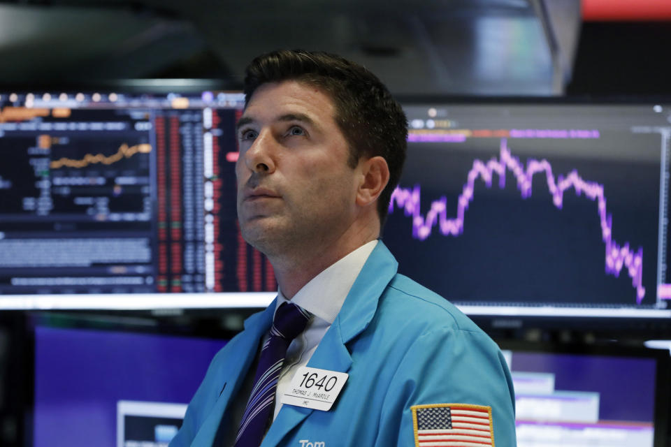 Trader Thomas McArdle works on the floor of the New York Stock Exchange, Wednesday, Aug. 14, 2019. The Dow Jones Industrial Average sank 800 points after the bond market flashed a warning sign about a possible recession for the first time since 2007. (AP Photo/Richard Drew)