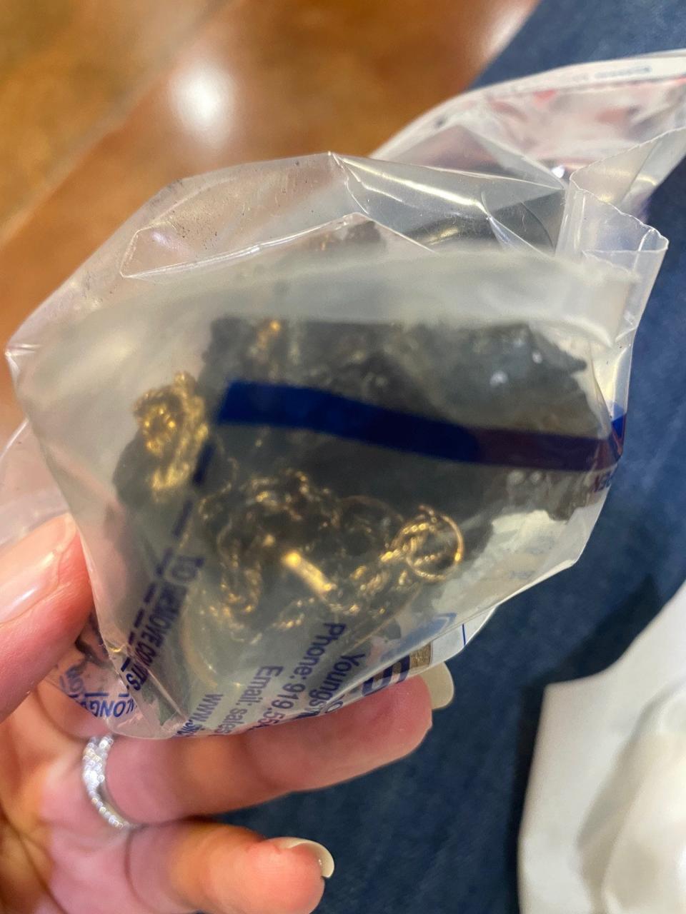 After Brian Kurz was killed in a fiery December 2021 car crash, his wife was given this evidence bag with his St. Christopher's necklace and wedding ring tangled in a block of char.