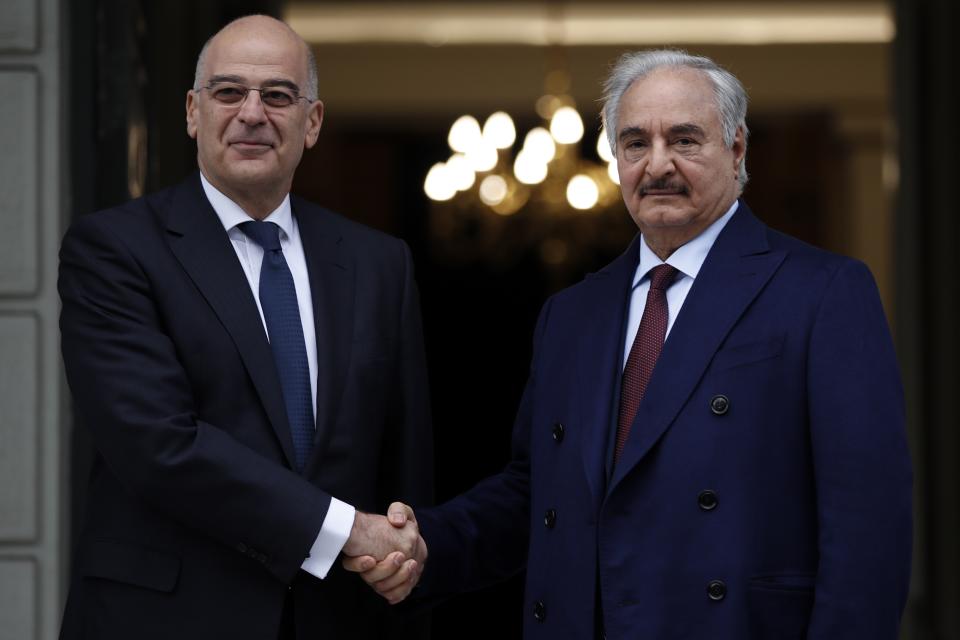 Libyan Gen. Khalifa Hifter, right, and Greek Foreign Minister Nikos Dendias shake hands before their meeting in Athens, Friday, Jan. 17, 2020. The commander of anti-government forces in war-torn Libya has begun meetings in Athens in a bid to counter Turkey's support for his opponents. (AP Photo/Thanassis Stavrakis)