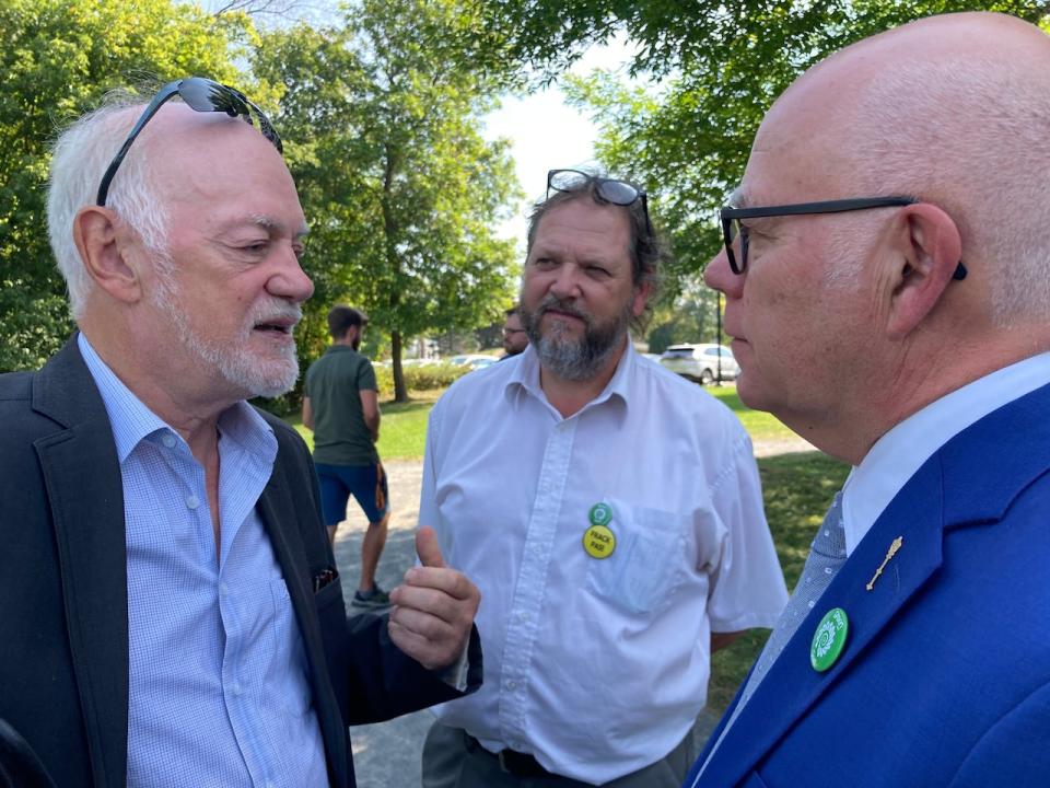 Green Leader David Coon talks to candidates Wilfred Roussel, left, and Jacques Giguère, centre, after the party's campaign launch on Sept. 18. 