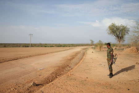 An Ethiopian military officer stands guard in the outskirts of Badme, a territorial dispute town between Eritrea and Ethiopia currently occupied by Ethiopia June 8, 2018. Picture taken June 8, 2018. REUTERS/Tiksa Negeri