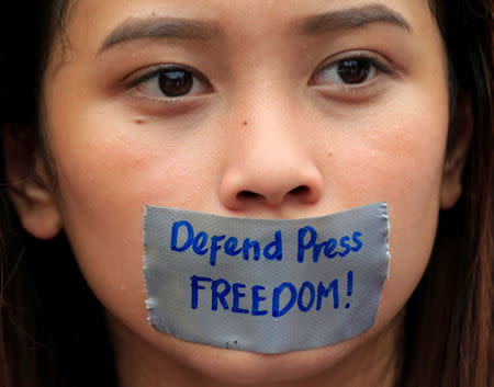 A member of the College Editors Guild of the Philippines has her mouth covered with duct tape during a protest outside the presidential palace in Metro Manila, Philippines January 17, 2018. REUTERS/Romeo Ranoco