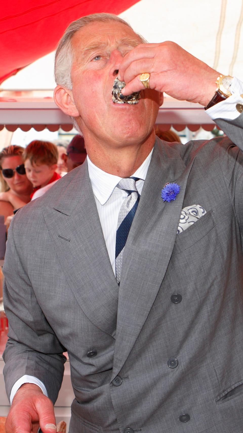 Prince Charles eating an oyster