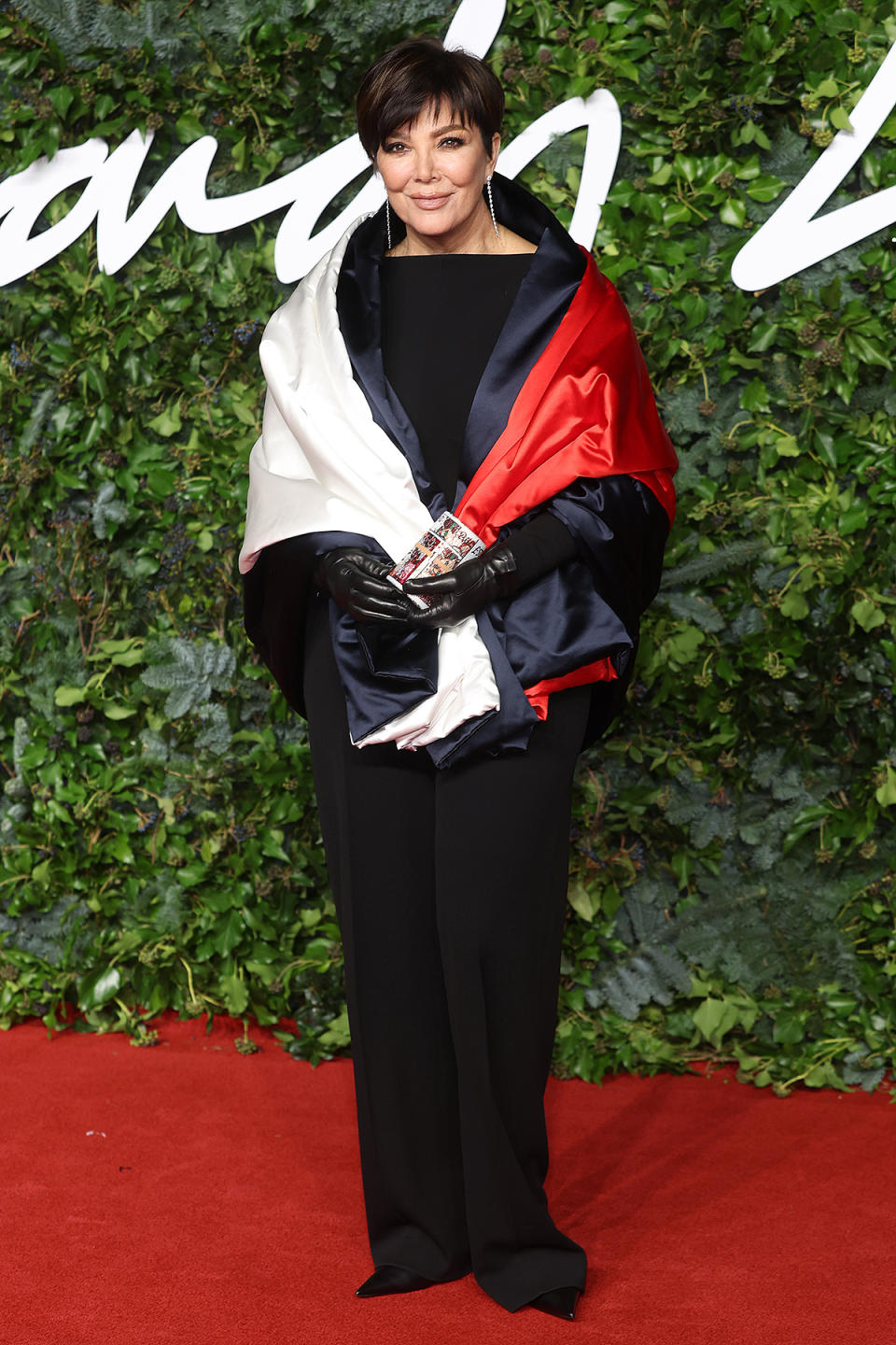 <p>wears a Tommy Hilfiger shawl and a sparkling money roll clutch. </p>