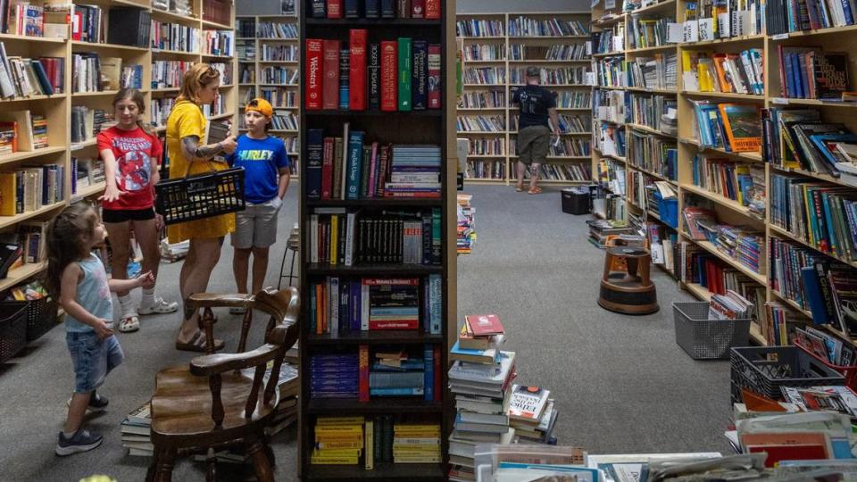 Katharina Martuscelli, of Boise, browses for books with her children Kloi, 12, Luca, 10, and Kennedy, 3.