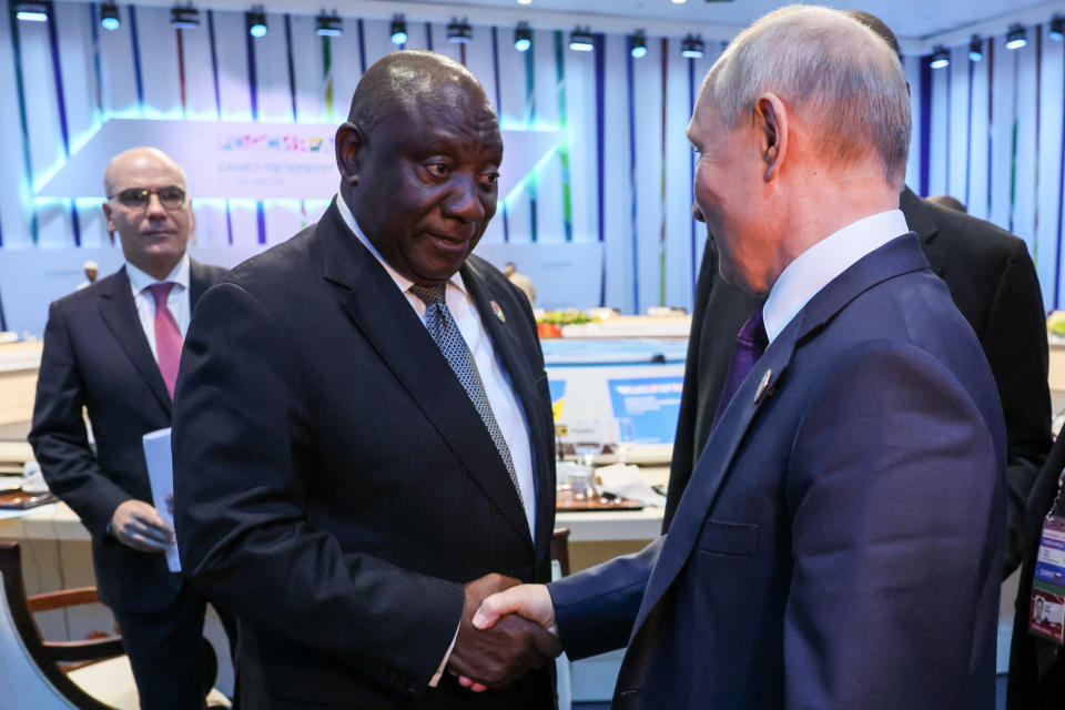 President of the Republic of South Africa Cyril Matamela Ramaphosa, left, and Russian President Vladimir Putin shake hands after a plenary session at the Russia Africa Summit in St. Petersburg, Russia, Friday, July 28, 2023. (Mikhail Metzel/TASS Host Photo Agency Pool Photo via AP)