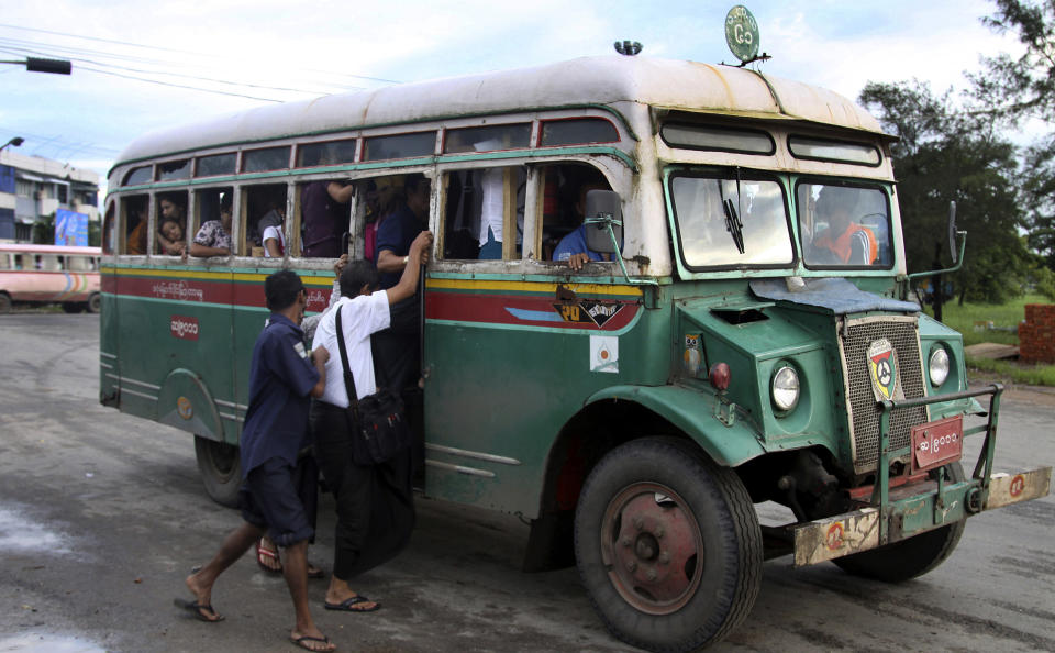 In this Aug. 22, 2012 photo, passengers get into a slowly moving Chevrolet bus in Yangon, Myanmar. These old Chevys built on the Canadian made military personnel carriers that were left behind after World War II were sent to the scrap heap at the end of 2012. Because of the abysmal state of public transport in Yangon, a city of 5 million, those who can afford to drive, do. Those who can’t cram into ancient buses perched precariously on huge tires or hitch rides on pickups outfitted with benches and makeshift roofs. (AP Photo/Khin Maung Win)