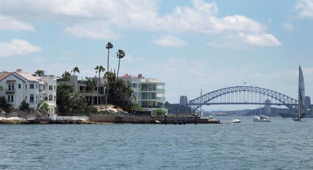 A sailing boat sails past homes located along the foreshore of Sydney Harbour in Australia, November 16, 2016. REUTERS/Jason Reed