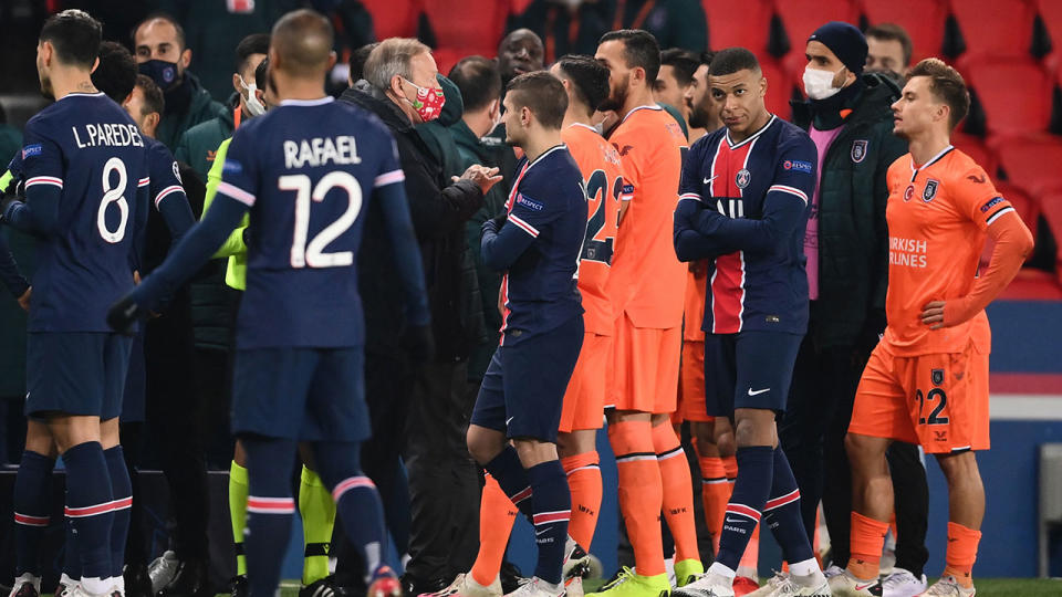 Players from PSG and Istanbul can be seen here discussing the incident with officials.