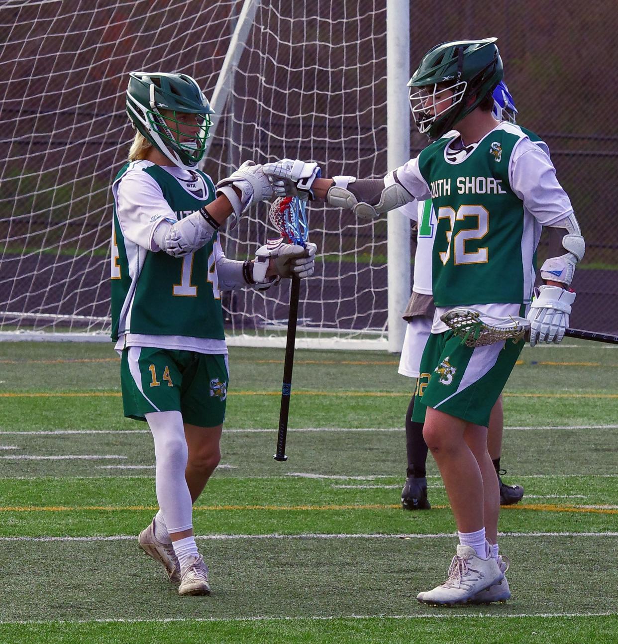 #32 Ben Tondorf of South Shore Tech gets a high five after scoring a goal against Blue Hills from teammate Todd Eagan during the lacrosse game on Wednesday, April 26, 2023. Eagan himself had a "Texas" hat trick, scoring four goals in the game.