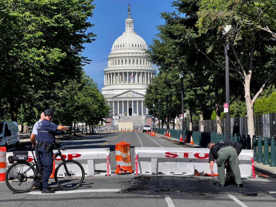 US Capitol Police Officers work near a police barricade on Capitol Hill in Washington, DC, on August 14, 2022 (AFP via Getty Images)