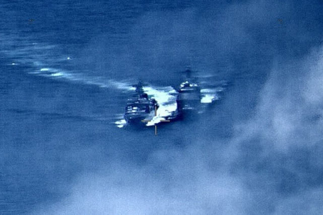 In this image provided by the U.S. Navy, a Russian destroyer, left, sails very close to the USS Chancellorsville, right, while operating in the Philippine Sea, Friday, June 7, 2019. The U.S. and Russian militaries accused each other of unsafe actions in the incident. (Photo by Petty Officer 1st Class Christopher J Krucke via AP)